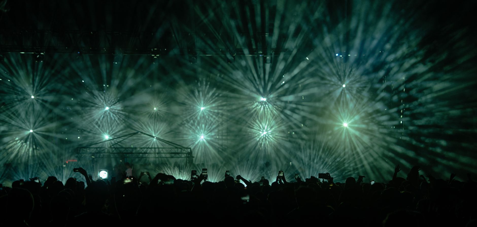 Captivating concert light show with a large crowd in Istanbul at night.